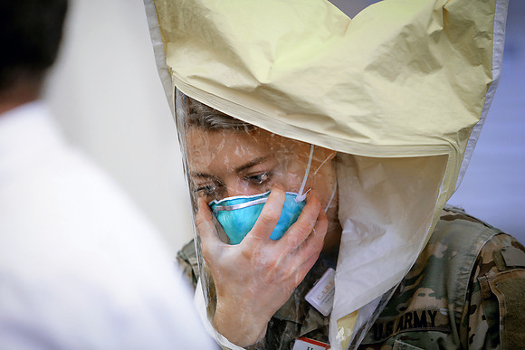 Hannah Earl, RN, US Army, a FEMA nurse, performs N95 mask fit testing at Rhode Island Hospital.